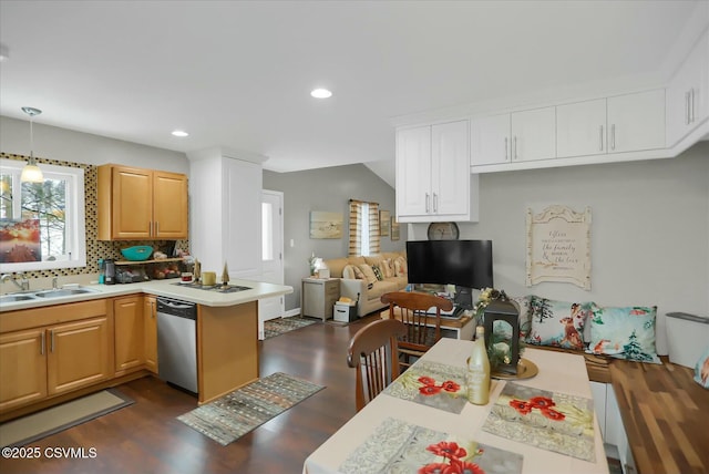 kitchen featuring dark wood-type flooring, sink, tasteful backsplash, hanging light fixtures, and stainless steel dishwasher