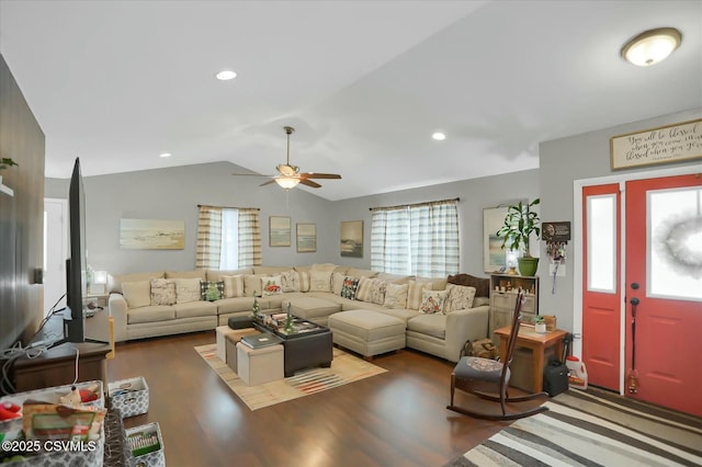 living room with lofted ceiling, ceiling fan, dark hardwood / wood-style floors, and a healthy amount of sunlight