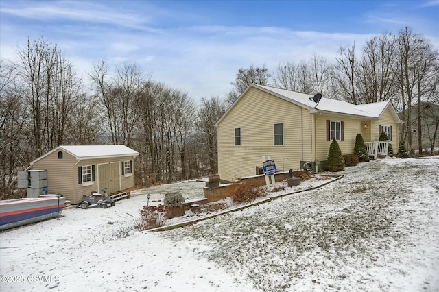 view of snowy exterior with an outbuilding