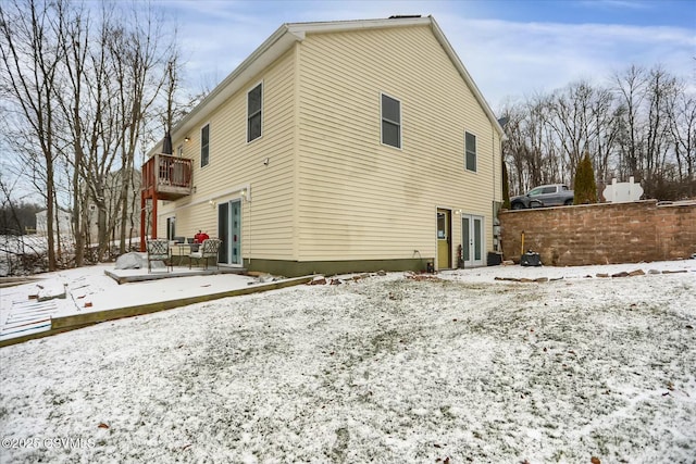 snow covered property featuring a balcony