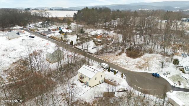 snowy aerial view with a mountain view