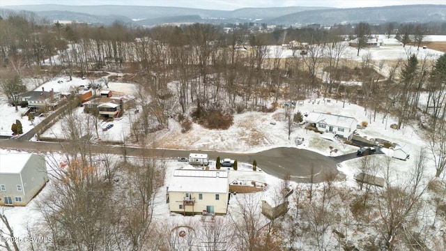 snowy aerial view with a mountain view