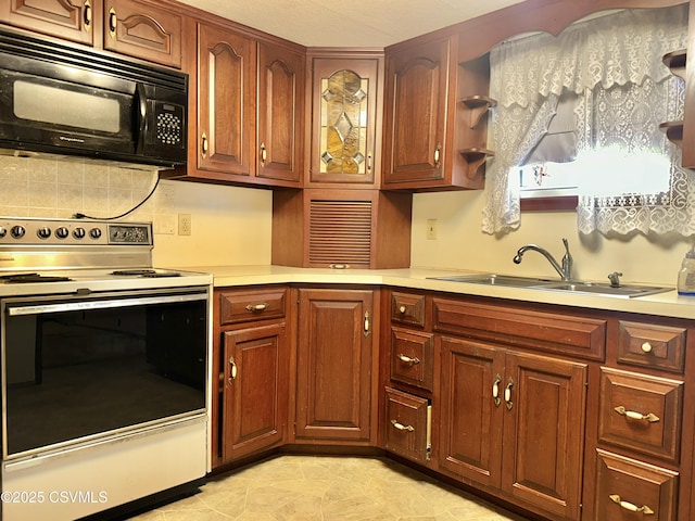 kitchen featuring electric stove, sink, and backsplash