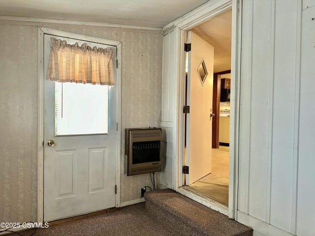 doorway with carpet flooring and heating unit