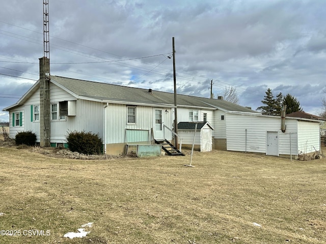 rear view of property with a lawn