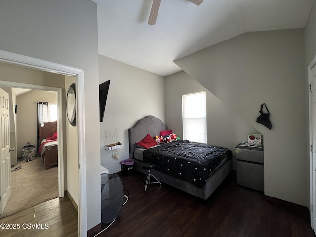 bedroom featuring ceiling fan, dark hardwood / wood-style flooring, and vaulted ceiling