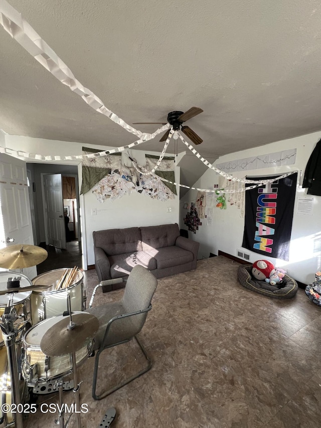 interior space featuring ceiling fan and a textured ceiling