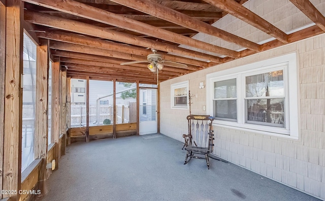 unfurnished sunroom with ceiling fan