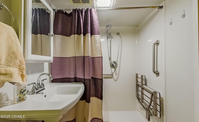 bathroom featuring sink and a shower with shower curtain