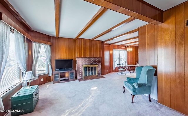 living room with wooden walls, beamed ceiling, a chandelier, and carpet