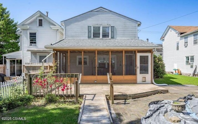 back of property with a patio area and a sunroom