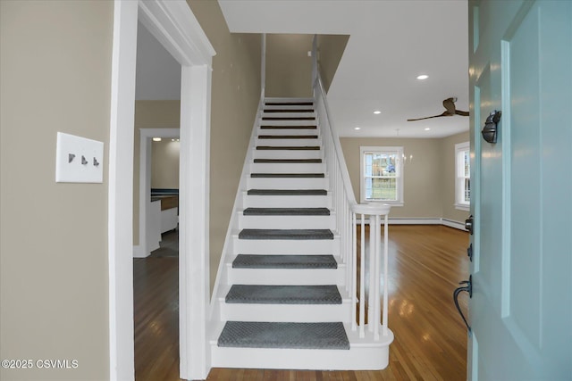 staircase with hardwood / wood-style flooring