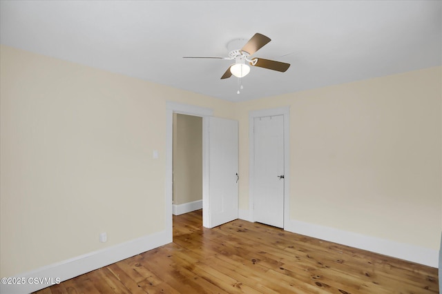 spare room with hardwood / wood-style flooring and ceiling fan