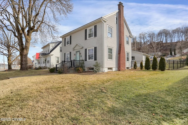 rear view of house featuring a yard