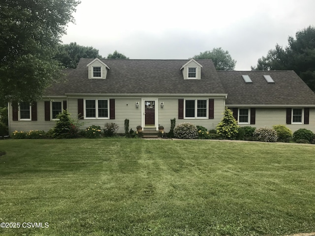 cape cod house with a front yard