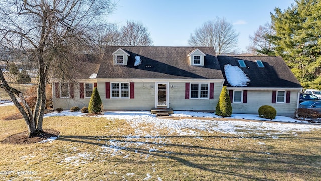 cape cod-style house featuring a lawn