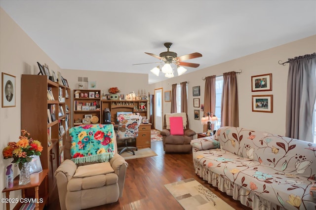 living room featuring hardwood / wood-style floors and ceiling fan