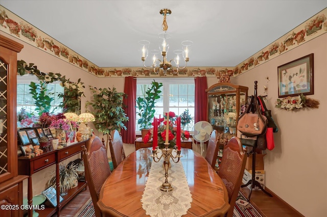 dining space with a chandelier and hardwood / wood-style floors