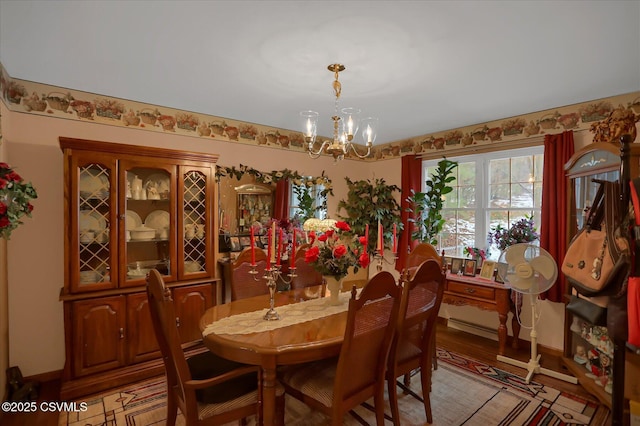 dining area with an inviting chandelier and light hardwood / wood-style floors