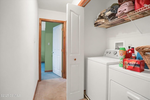 clothes washing area with washing machine and dryer and light carpet