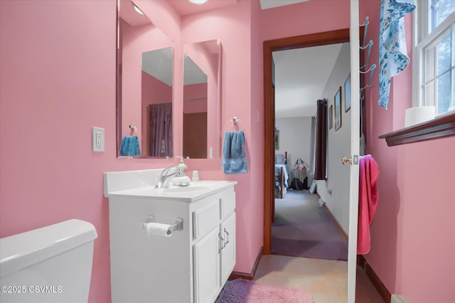 bathroom featuring vanity and toilet