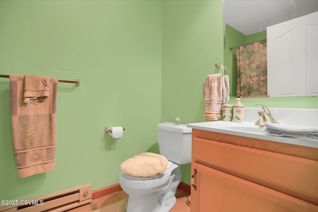 bathroom featuring curtained shower, tile patterned flooring, vanity, baseboard heating, and toilet