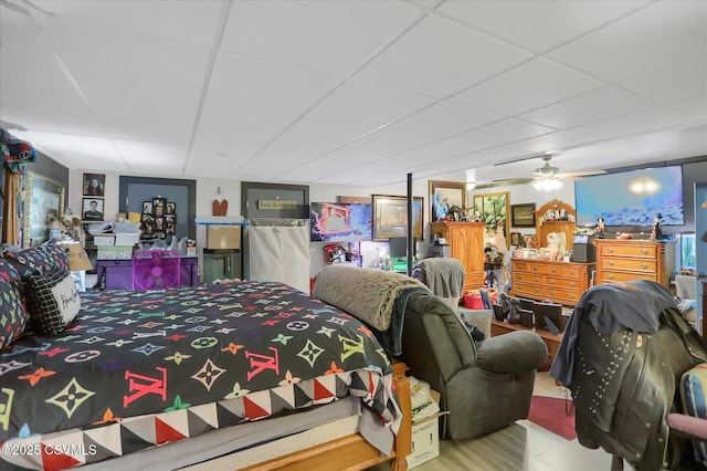 bedroom featuring a paneled ceiling and wood-type flooring