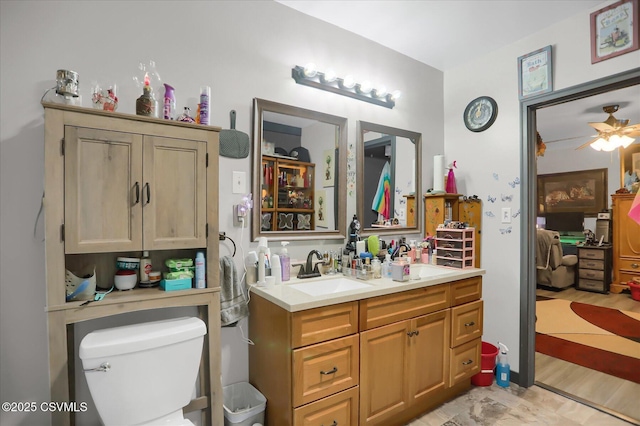 bathroom featuring vanity, ceiling fan, and toilet