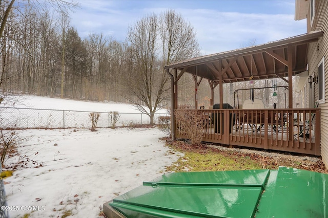 snowy yard featuring a deck