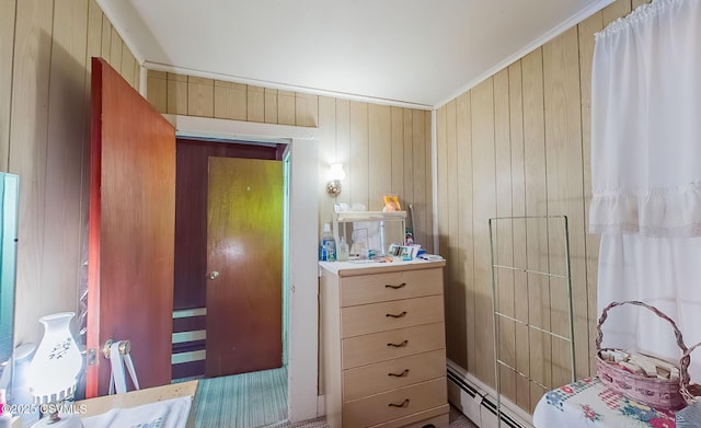 bedroom with crown molding and baseboard heating