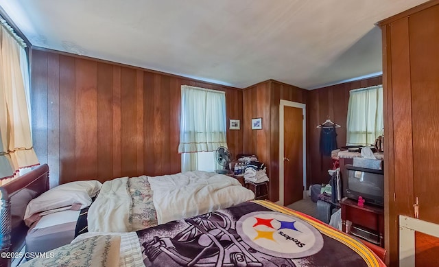 bedroom featuring wooden walls