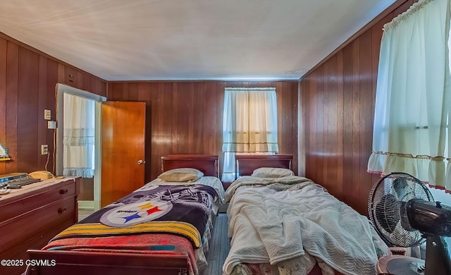 bedroom featuring wood walls