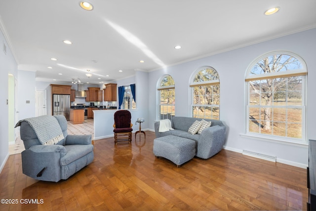 living room with crown molding and light hardwood / wood-style floors