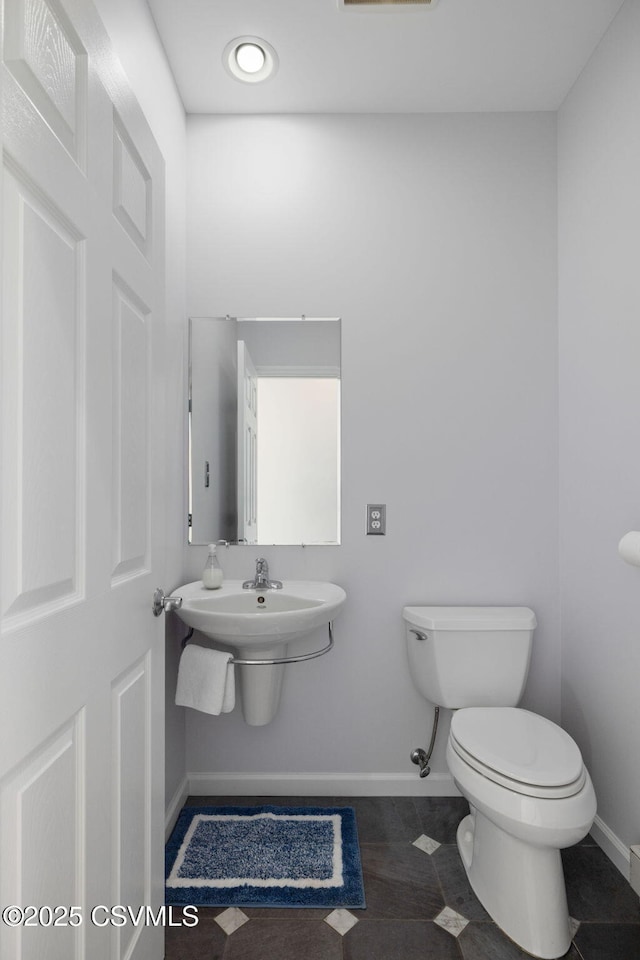 bathroom featuring tile patterned flooring and toilet