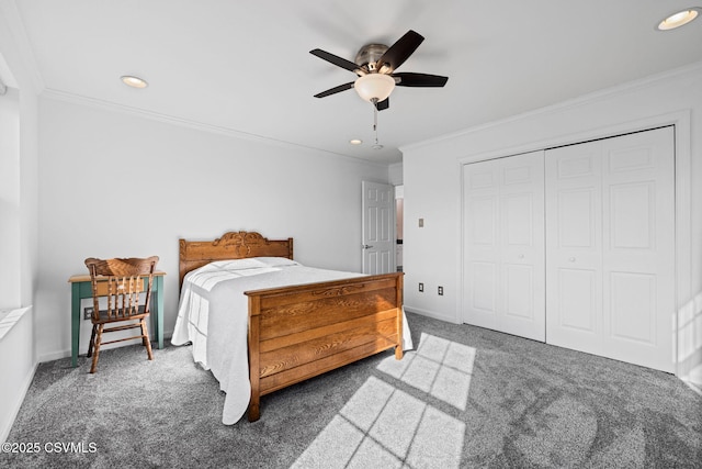 bedroom featuring crown molding, ceiling fan, dark carpet, and a closet