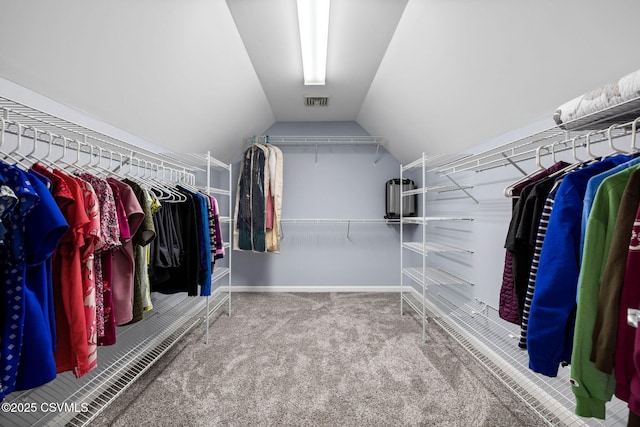 spacious closet with lofted ceiling and carpet floors