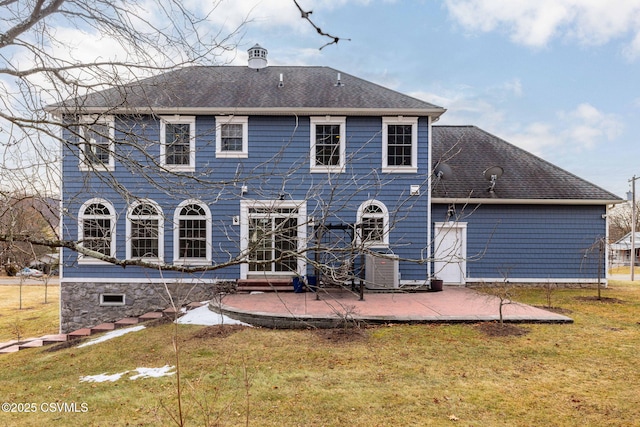 back of property featuring a lawn and a patio area