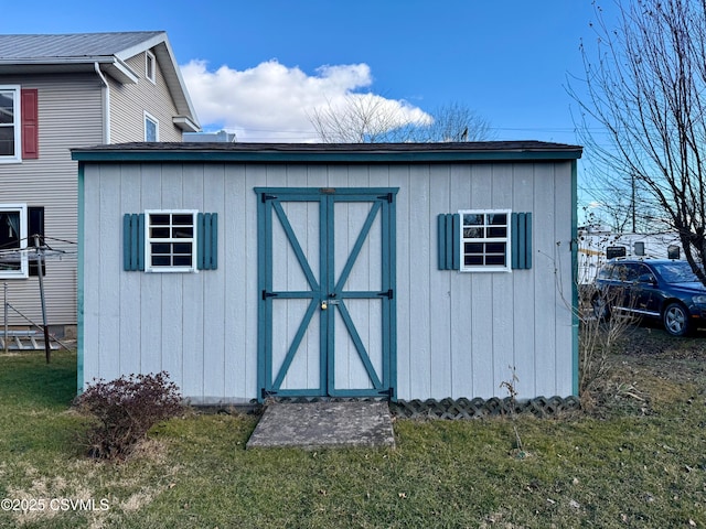 view of outbuilding featuring a lawn