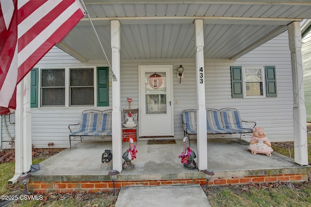 view of exterior entry with covered porch