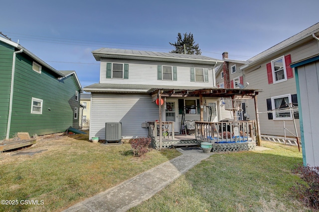 view of front of home featuring a wooden deck, central air condition unit, and a front lawn