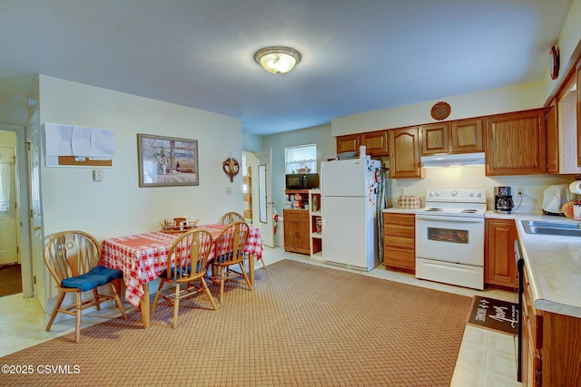 kitchen featuring sink and white appliances