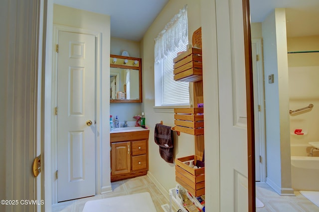 bathroom with vanity and a tub