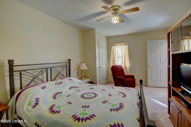 carpeted bedroom featuring ceiling fan