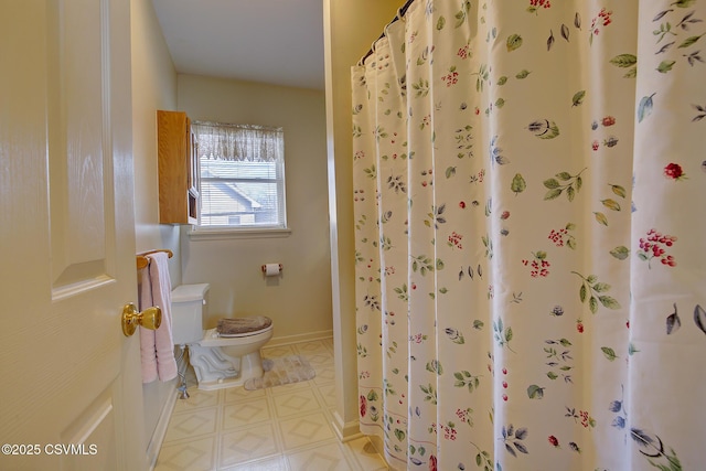 bathroom with toilet and walk in shower