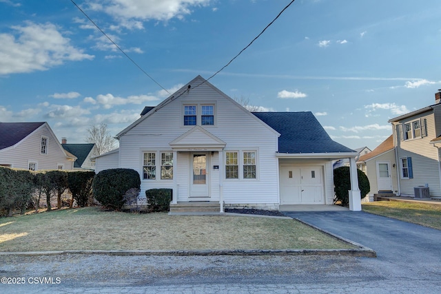 bungalow-style home with central AC and a front lawn