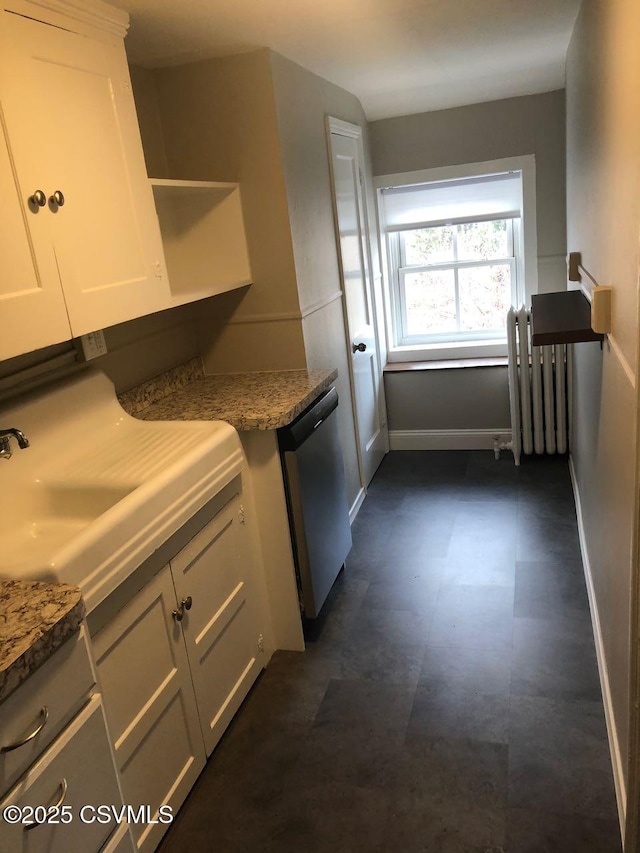 kitchen with light stone counters, dishwasher, and white cabinets