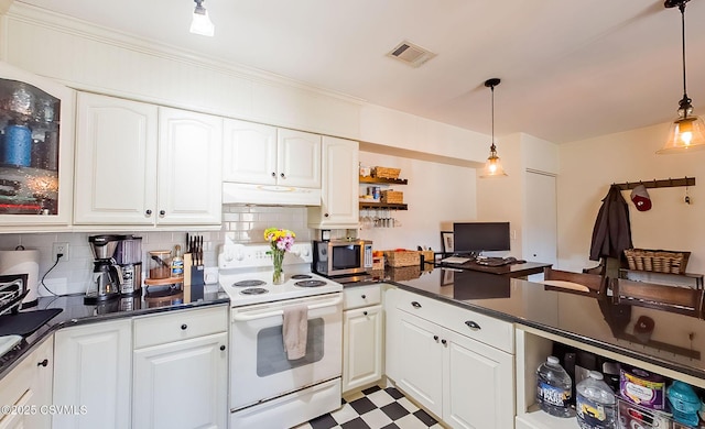 kitchen featuring tasteful backsplash, white range with electric cooktop, decorative light fixtures, and white cabinets