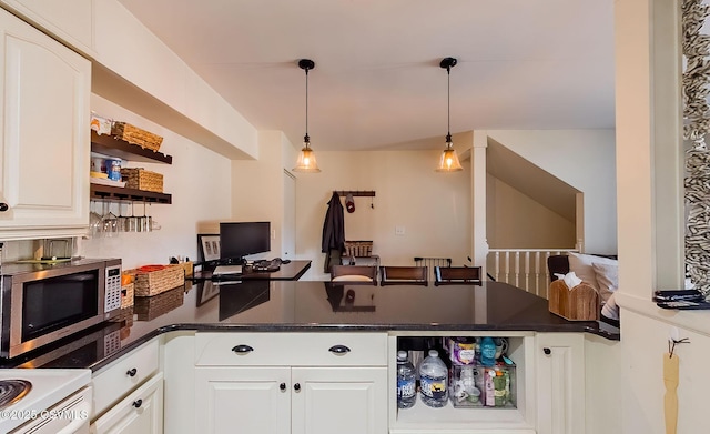 kitchen featuring white cabinetry, decorative light fixtures, and dark stone counters