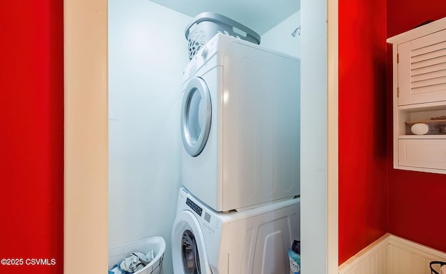 laundry room with stacked washer / dryer