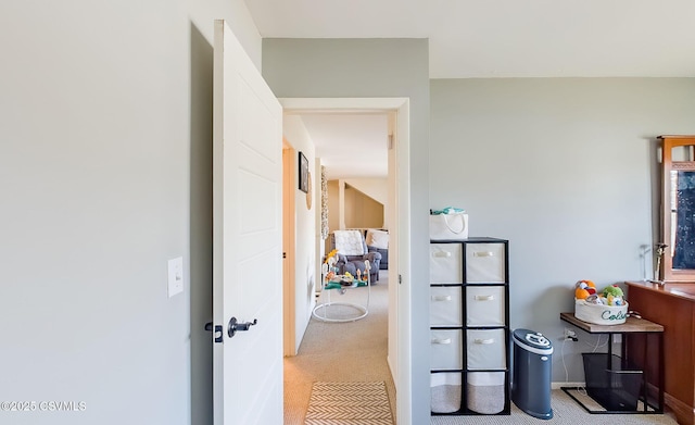 hallway featuring light carpet